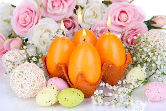 Easter candles with flowers close up