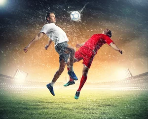 Acrylic prints Football two football players striking the ball