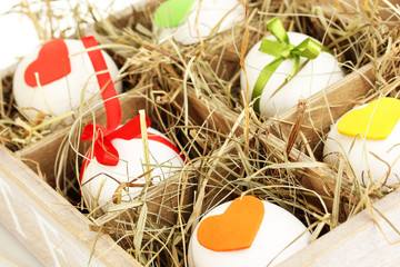 Decorative Easter eggs in wooden basket close up