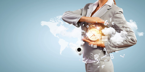 Business man holding alarmclock