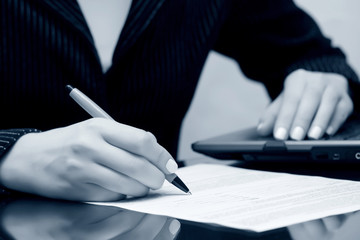Female hand signing contract