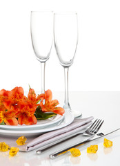 Festive table setting with flowers isolated on white