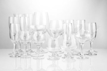 Cocktail and wine glasses, on gray background
