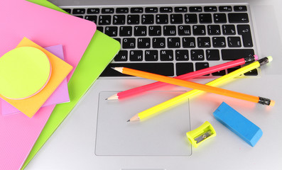 Laptop with stationery close-up