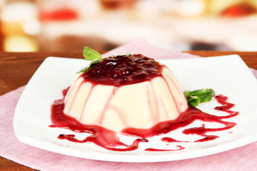 Panna Cotta with raspberry sauce, on bright background