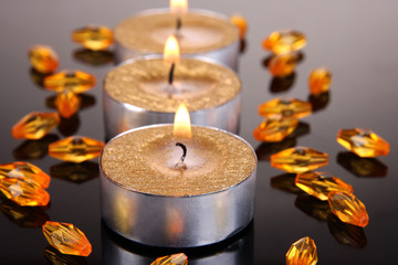 Golden candles isolated on black