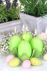 Easter candles with flowers close up