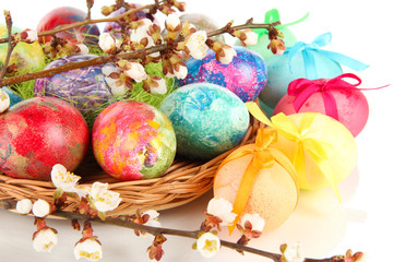 Beautiful Easter eggs in wicker basket close-up