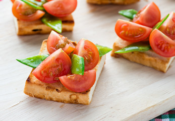 Bruschetta with fresh tomato and snow peas