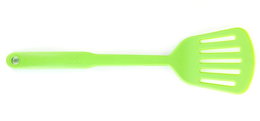 Green plastic kitchen utensil isolated on white