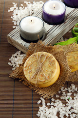 Hand-made soap and sea salt  on grey bamboo mat