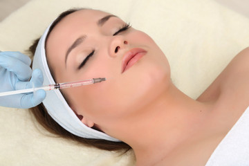Young woman receiving plastic surgery injection
