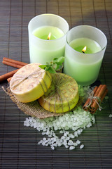 Hand made soap and candles on bamboo mat background