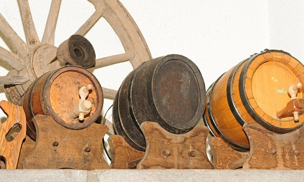 Wooden wagon wheel and antique wooden small draught beer keg