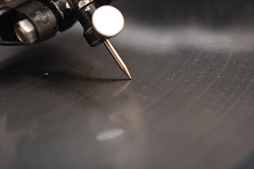 old gramophone needle and a black vinyl © vadim yerofeyev