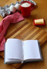 Open notebook for recipes with baking ingredients