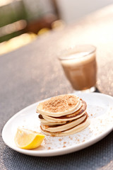 Fototapeta na wymiar weekend breakfast of mini pancakes and cafe latte