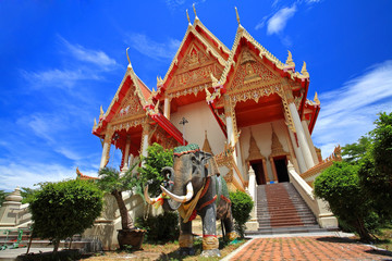 Elephant statue in front of large temple