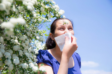 Allergic woman sneezing in handkerchief - obrazy, fototapety, plakaty