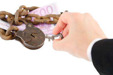 money security concept - hand with key try to unlock money - iso