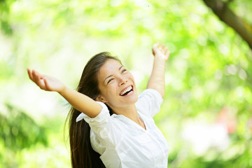 Carefree elated cheering woman in spring or summer