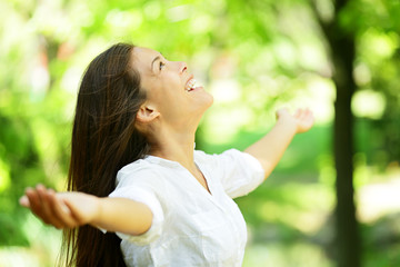 Young woman rejoicing in a spring or summer garden