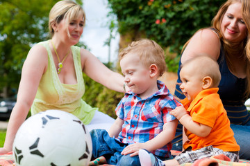 Mother and grandmother with children in a park