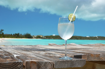 Glass of water against ocean
