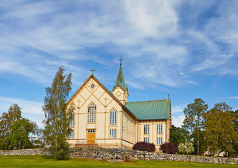 Fototapeta na wymiar The Finnish wooden rural Catholic church in the sunny summer da