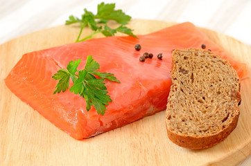 Salted salmon fillet, parsley and slice of bread