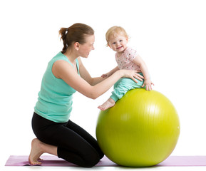 Fototapeta na wymiar mother with baby having fun with gymnastic ball
