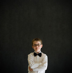 Arms folded boy dressed up as business man