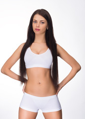 Obraz premium beautiful young brunette sportswoman isolated white background
