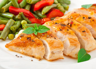 Chicken breast with vegetables and sauce decorated with basil