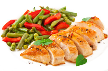 Chicken breast with vegetables and sauce decorated with basil
