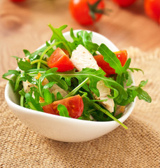 grilled fillet of chicken and a salad of arugula and tomato