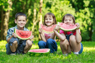 Three happy smiling child playing in park