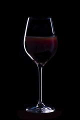 Glass of red wine on black