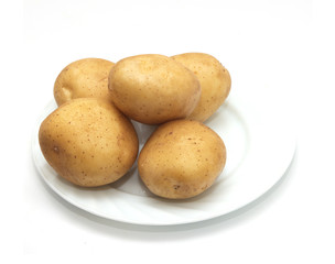 fresh potatoes on the plate on white background