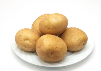 fresh potatoes on the plate on white background