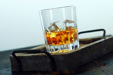 Glass of scotch and ice in a tray