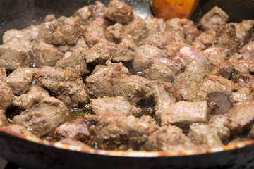 Liver is fried in a pan