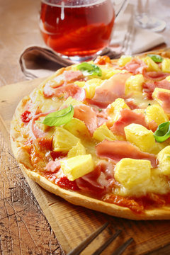 Appetising ham and pineapple Italian pizza
