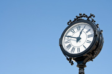 Fototapeta na wymiar vintage style city clock against blue sky