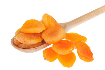 Dried apricots in a wooden spoon