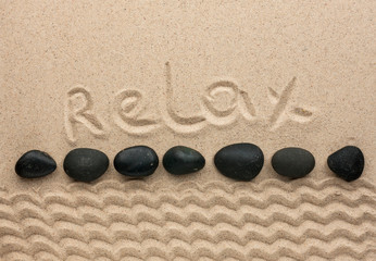 Fototapeta na wymiar The word relax written on the sand
