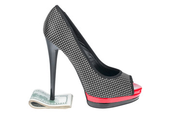 Women's shoes stand on the money