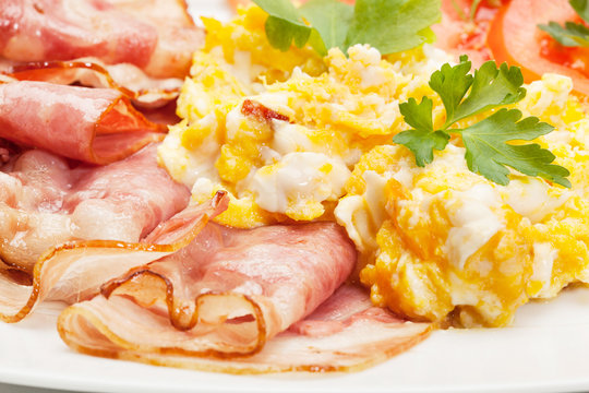 Scrambled eggs with bacon. Selective focus.