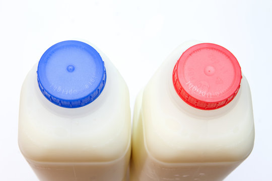 skimmed and full fat milk in containers