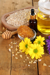Fragrant honey spa with oils and honey on wooden table close-up